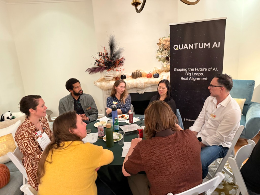 Roundtable discussion at the founding dinner with Quantum AI banner